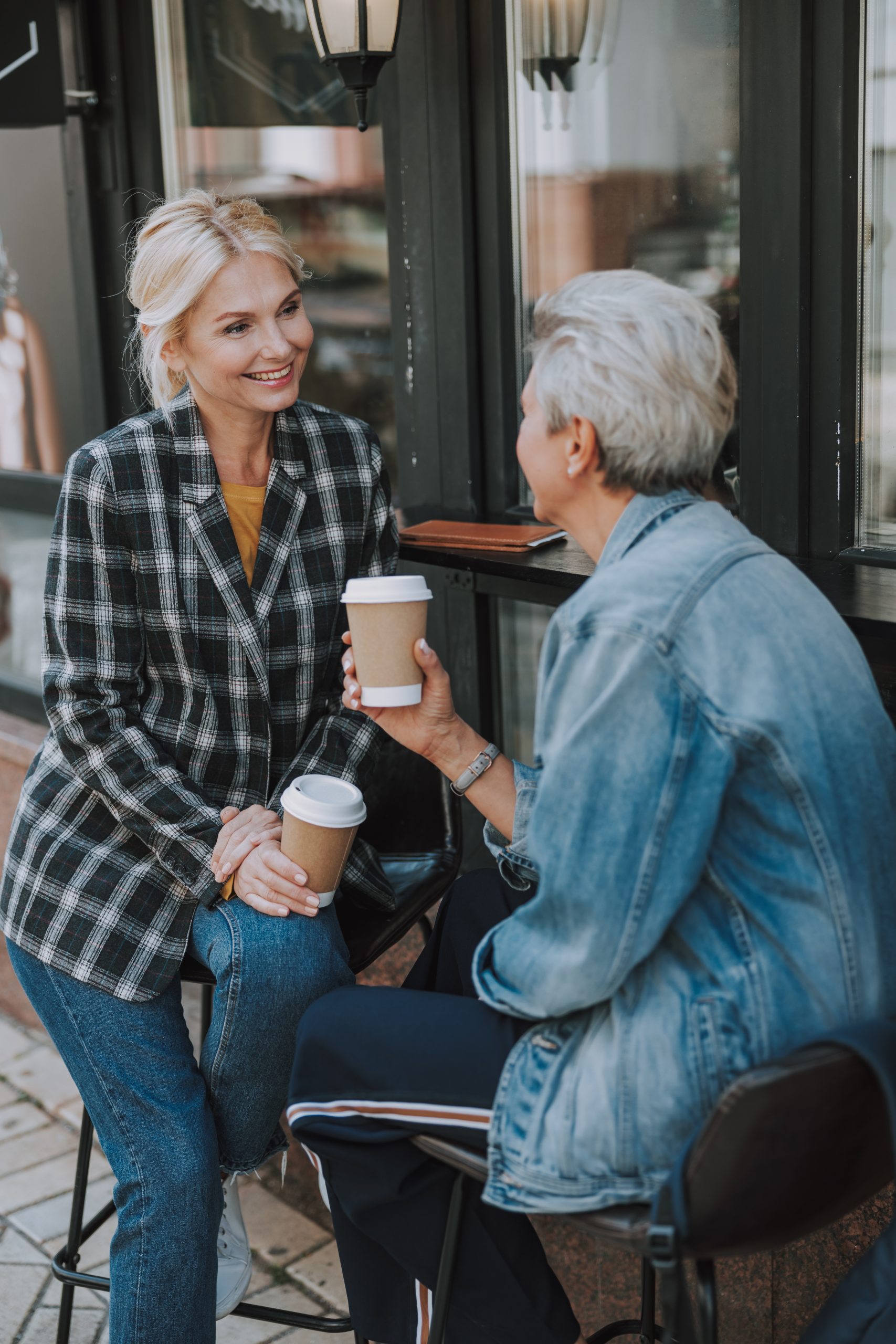 Lady talking to her female friend outdoors